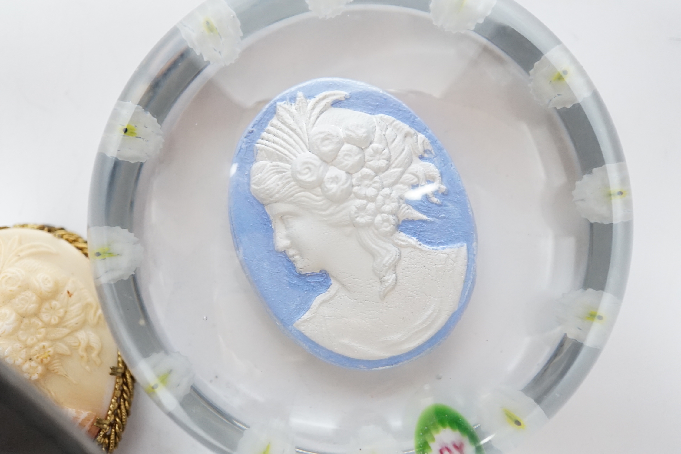 A rare Paul Ysart ‘Grecian Head’ sulphide portrait glass paperweight, ‘PY’ cane, the sulphide plaque of a lady with ‘P. Ysart’ signature to the reverse, 8cm diameter, together with a glass cameo effect brooch from which